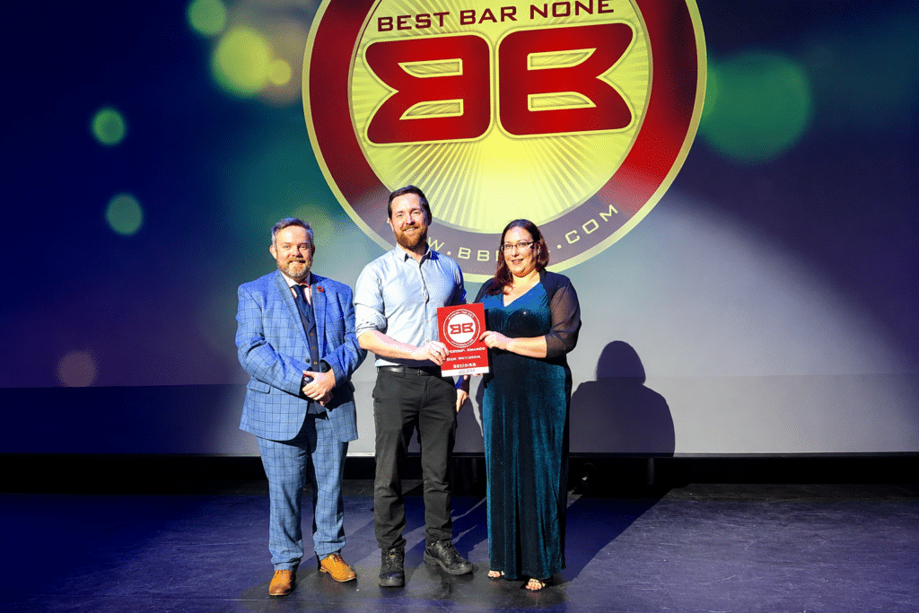 Steph Austin presenting the Best Bar award on stage at Guildford Best Bar None Awards, October 2022. Alt text: Stephanie Austin, founder of Prima Cura Training, presenting the Best Bar national category award at the Guildford Best Bar None Awards ceremony, October 2022