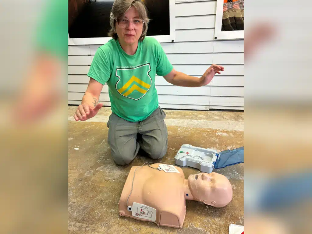 The owner of Underbanks Gallery in Stockport practising CPR on a manikin during Prima Cura Training first aid and risk assessment training