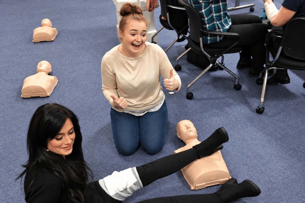 Staff from a Greater Manchester organisation practising their skills in an Emergency First Aid at Work with Prima Cura Training